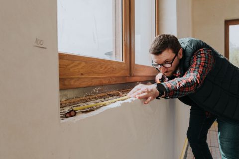carpenter measuring window ledge in new house 2023 11 27 04 50 23 utc