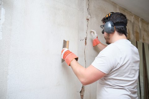 construction worker repairing a crack plastering 2023 11 27 05 06 20 utc