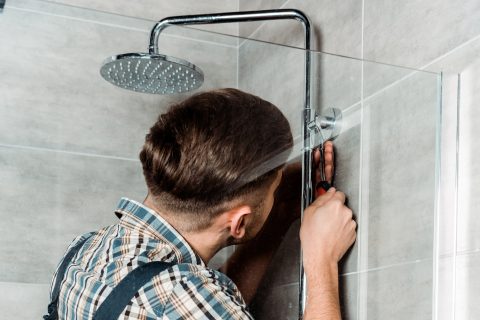 installer standing in bathroom and installing pipe 2023 11 27 05 16 15 utc