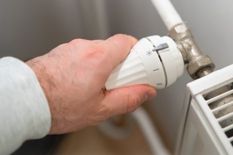 man hand regulates temperature knob of heating rad 2023 11 27 05 30 51 utc