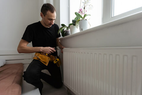 man is repairing radiator battery in the room mai 2023 11 27 05 37 24 utc