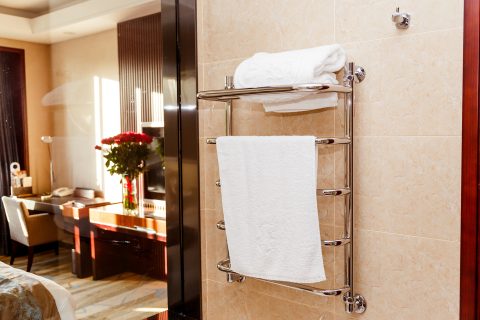 modern heated towel rail on tiled in hotel 2023 11 27 05 22 34 utc